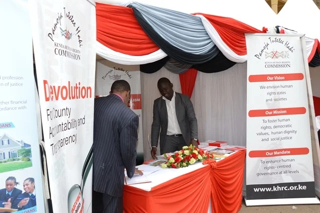 Morgan Ayieko of KHRC attending to visitors at the commission's stand