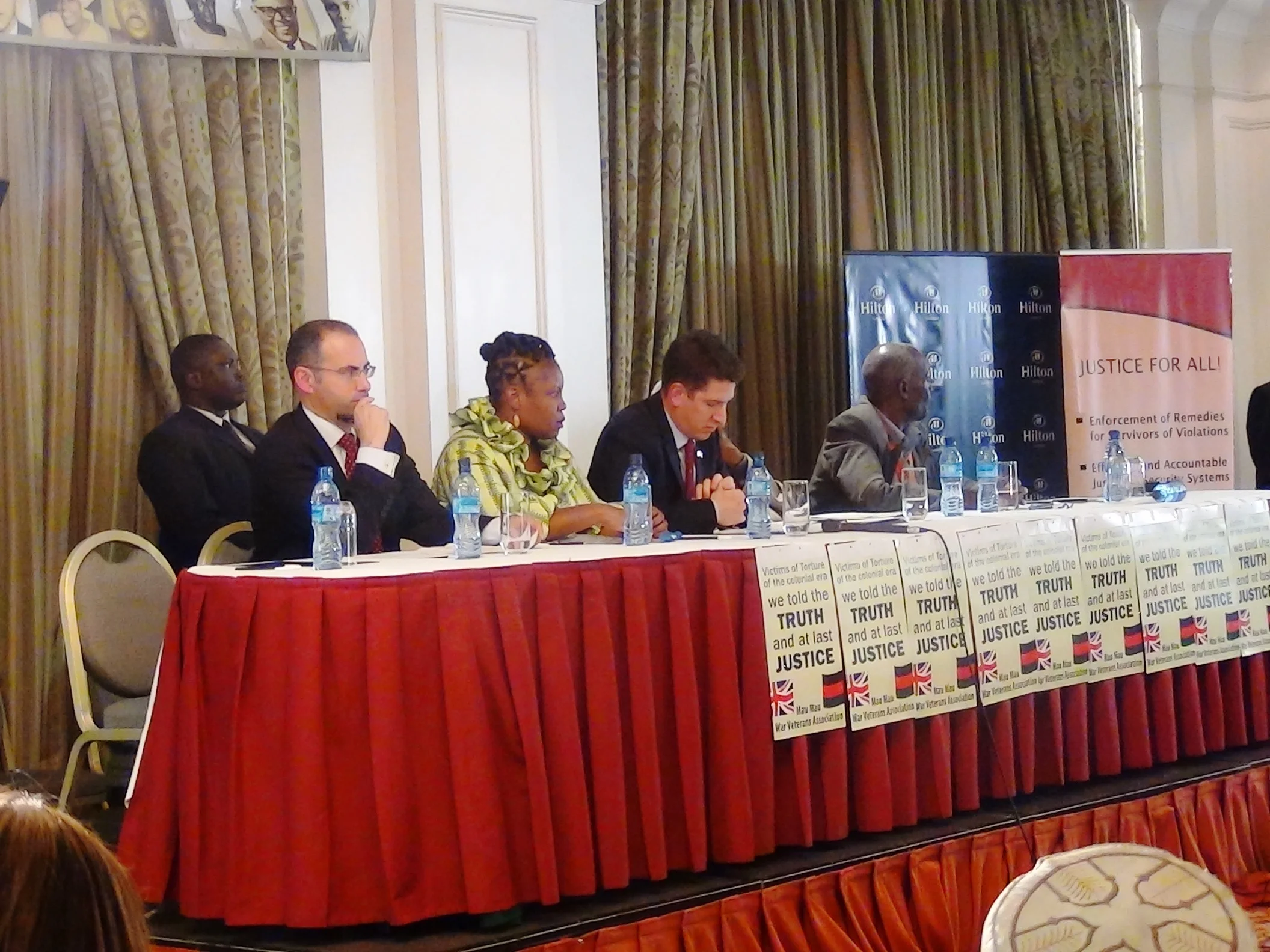 From left to right ( front raw) Dan Leader (partner at Leigh Day&Co) Atsango Chesoni (Executive Director KHRC), Dr. Chris Turner ( British High Commissioner to Kenya), Kiburu M’marete( Vice-chair, MMWVA). Security ( back row